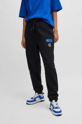 Cotton-terry tracksuit bottoms with Happy HUGO logo