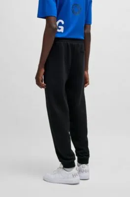 Cotton-terry tracksuit bottoms with Happy HUGO logo