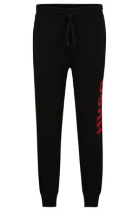 Cuffed tracksuit bottoms in French terry with contrast logo