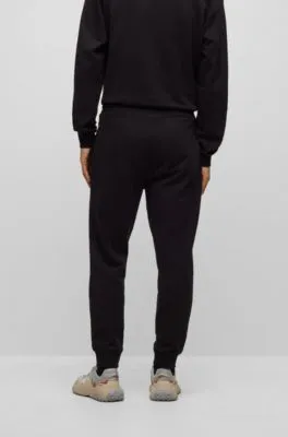 Cuffed tracksuit bottoms in French terry with contrast logo