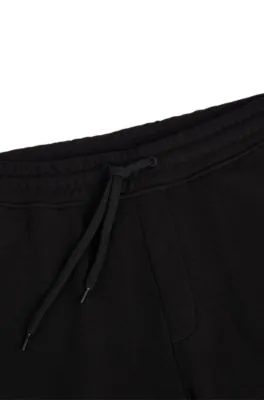 Cuffed tracksuit bottoms in French terry with contrast logo