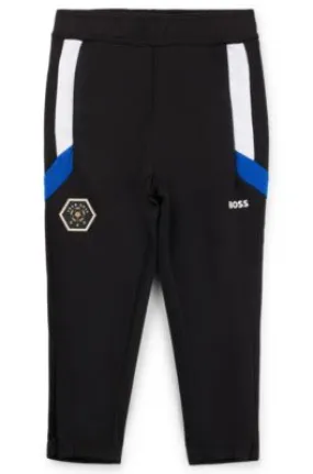 Kids' tracksuit bottoms with stripes and logo details