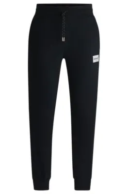 Tracksuit bottoms with metallic logo label