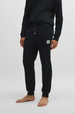 Tracksuit bottoms with metallic logo label